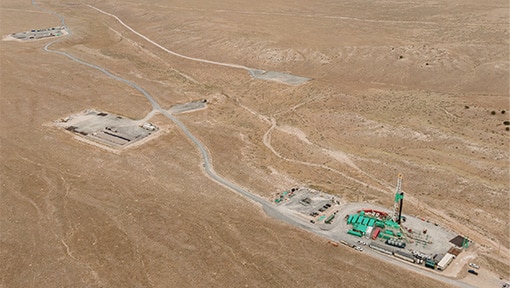 Forbes-Dec4-510×288 Aerial view of site with well pads and drill rig